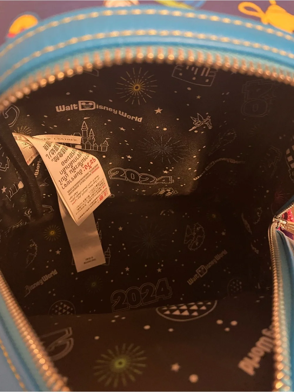 Loungefly Blue Mini Backpack with Pink Trim and Multicolor Disney Icons